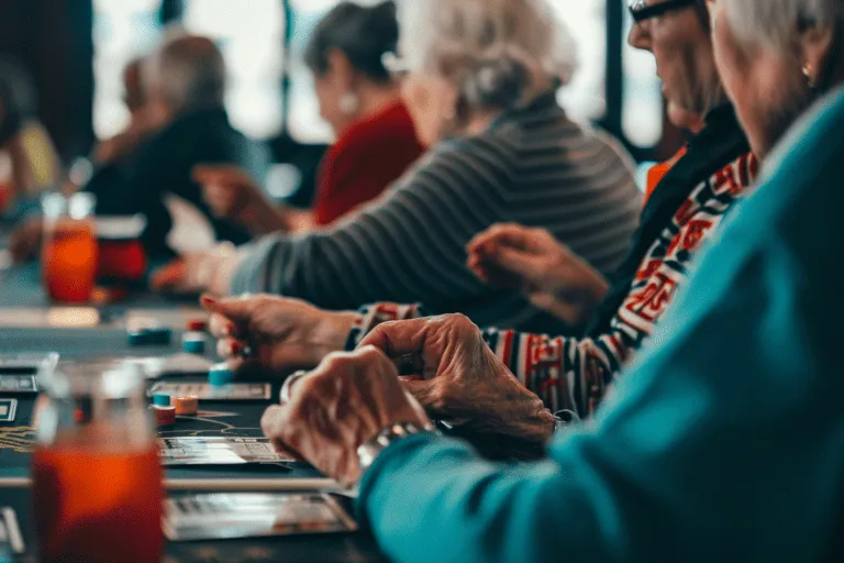 A group of older people playing cards at a table.